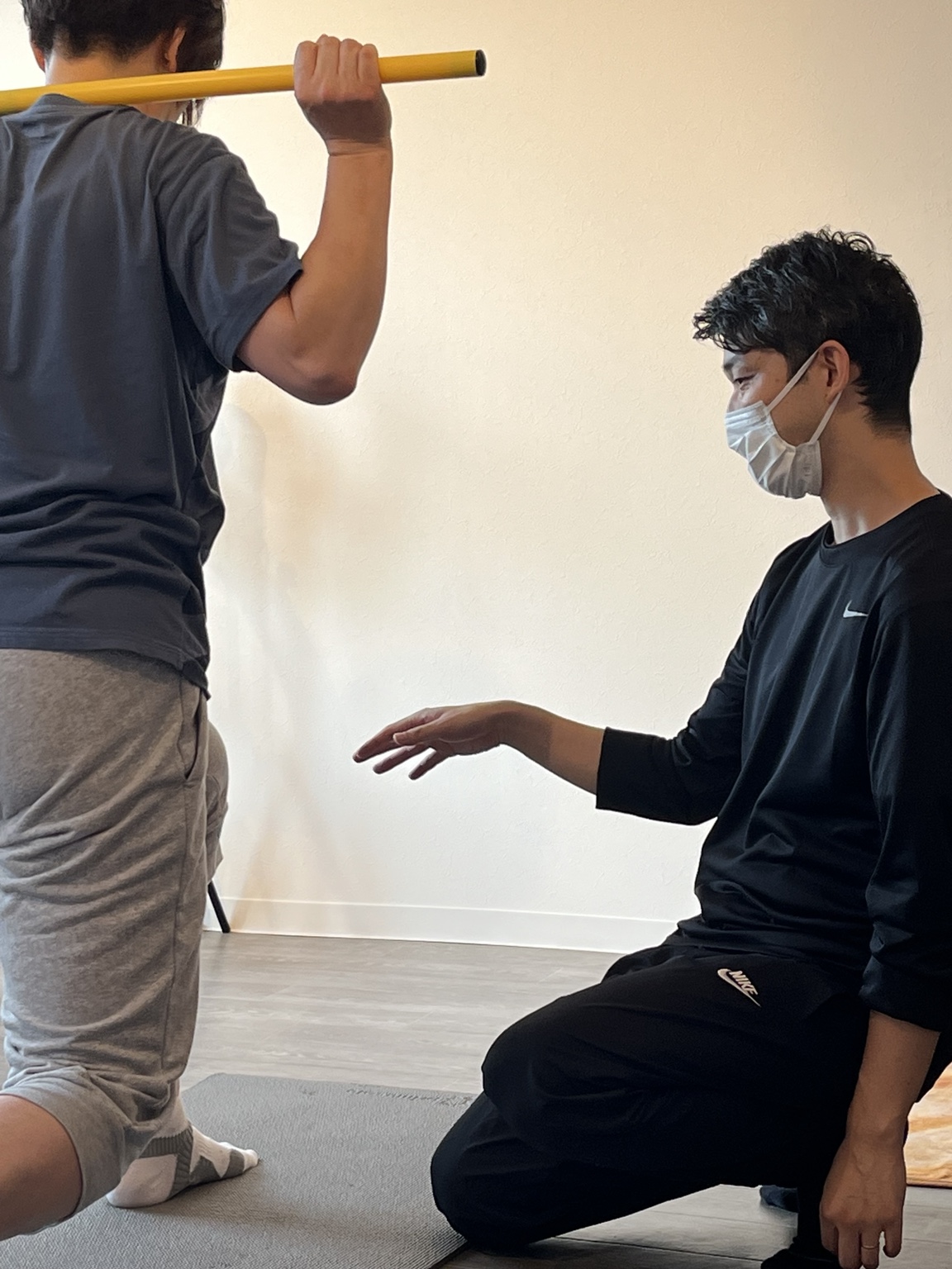 利用者の動きを近くで確認しながら指導するトレーナー